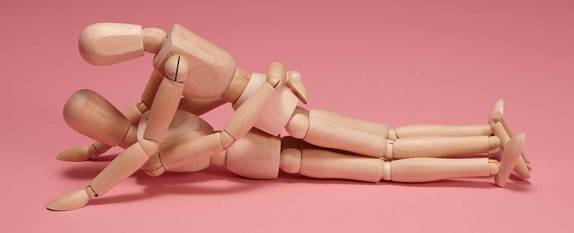 Wooden dolls in missionary position