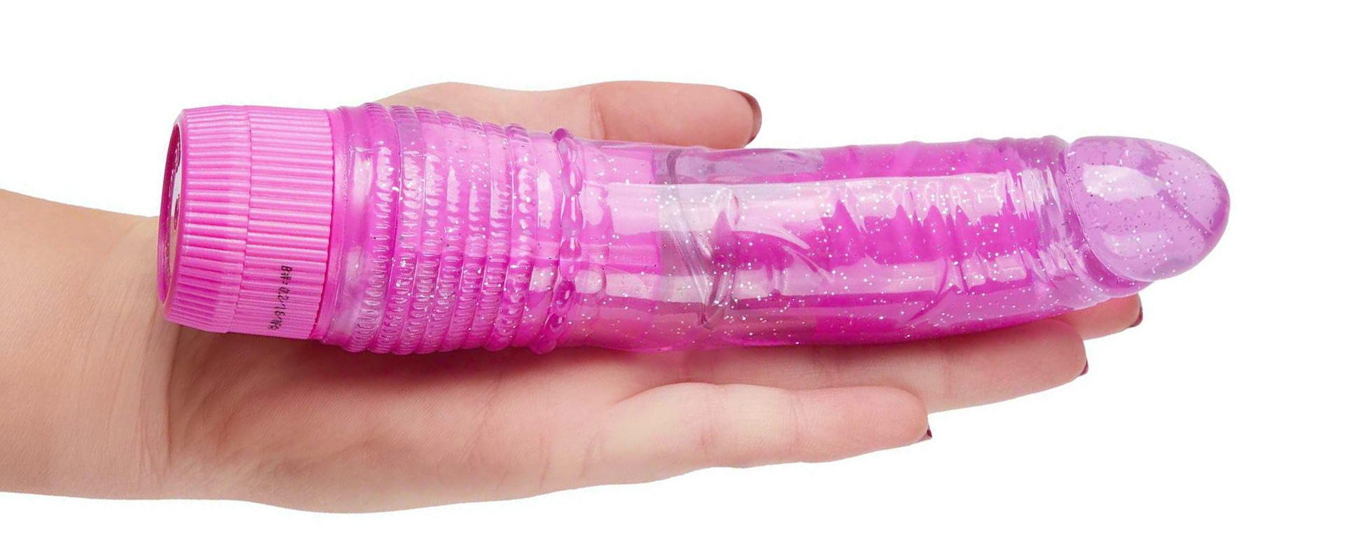 Hand holding a pink glittery dildo