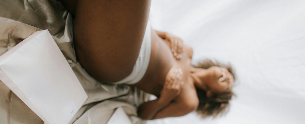 Person lying in bed happy
